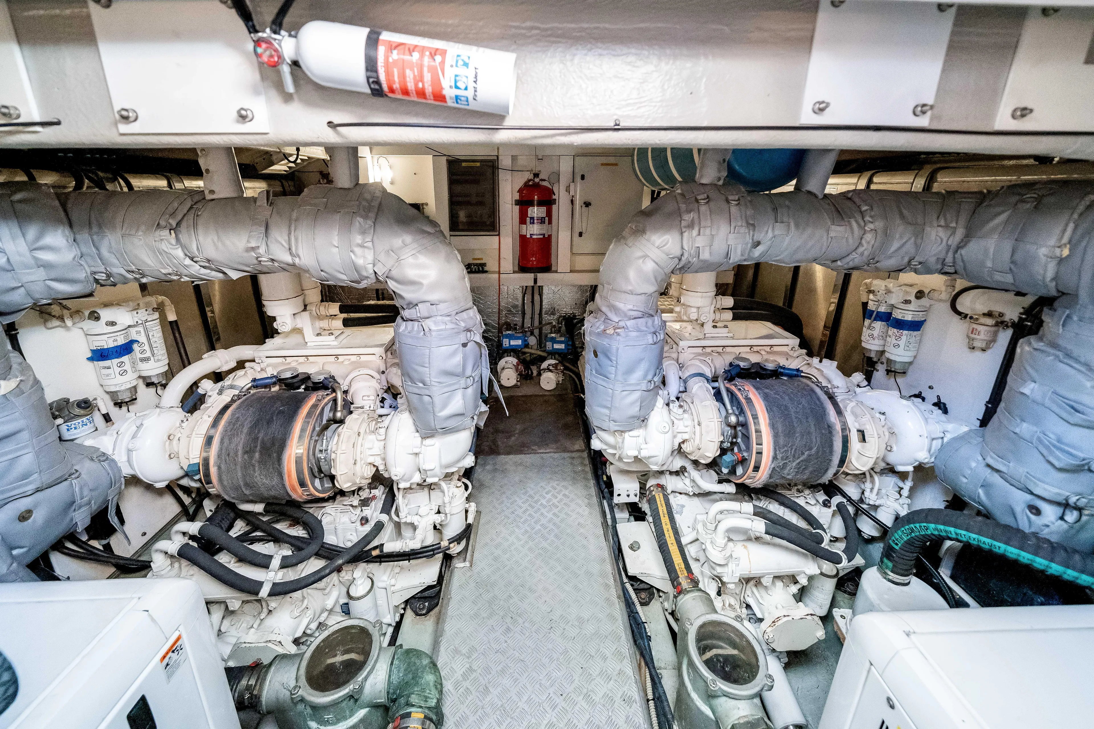 Twins Yacht Photos Pics Engine room of 2009 Sunseeker Manhattan 70 yacht, featuring dual engines and safety equipment.