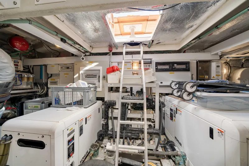 Twins Yacht Photos Pics Engine room of 2009 Sunseeker Manhattan 70 yacht, featuring equipment and ladder access.