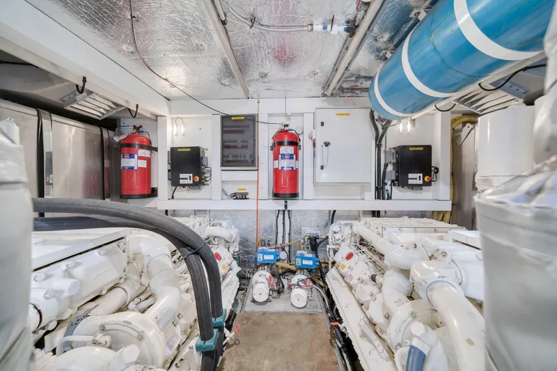 Twins Yacht Photos Pics Engine room of 2009 Sunseeker Manhattan 70 yacht, featuring dual engines and safety equipment.
