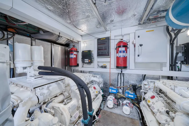 Twins Yacht Photos Pics Engine room of 2009 Sunseeker Manhattan 70 yacht, featuring machinery and fire extinguishers.