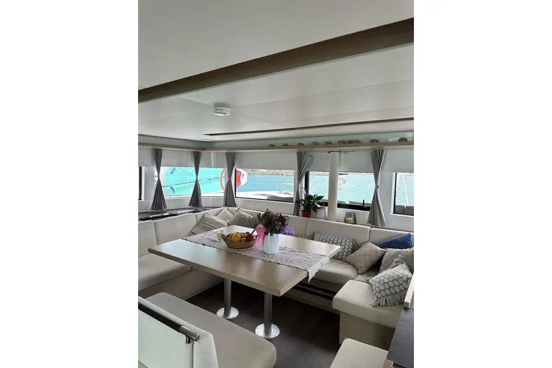  Yacht Photos Pics Luxurious interior of 2024 Lagoon 51 yacht with elegant seating and dining area.