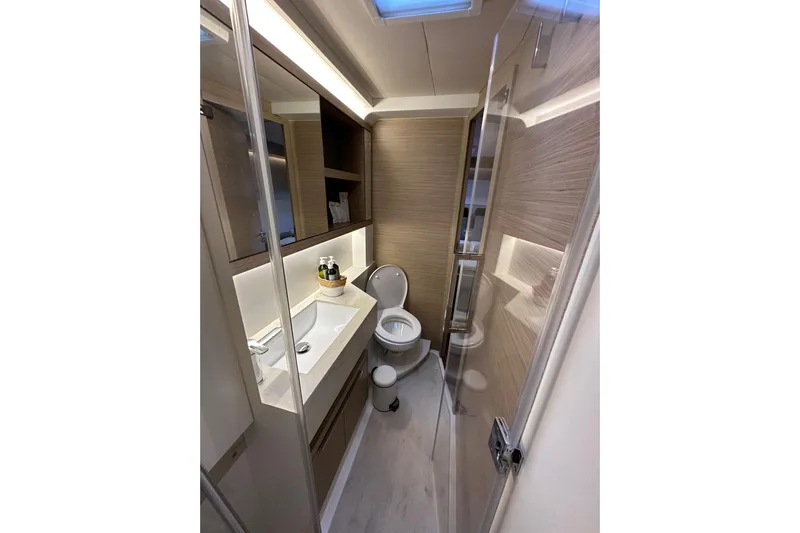  Yacht Photos Pics Modern bathroom interior of 2024 Lagoon 51 yacht, featuring sleek design and amenities.