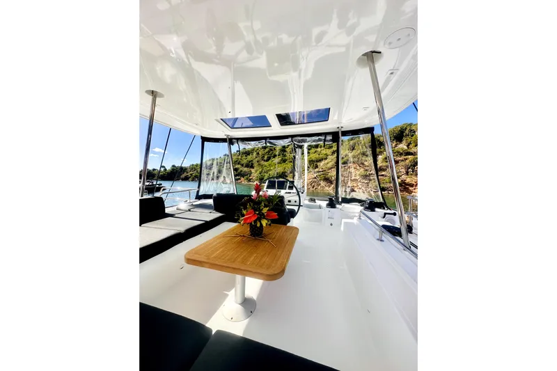  Yacht Photos Pics Luxurious interior of 2024 Lagoon 51 yacht with elegant seating and scenic views.
