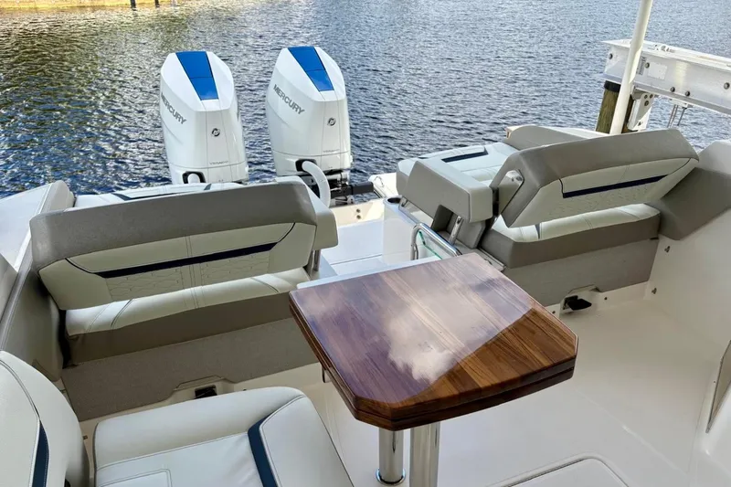 Liquid Asset Yacht Photos Pics 2024 Tiara Yachts 34 LX interior with seating and twin Mercury outboard engines.