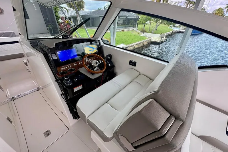 Liquid Asset Yacht Photos Pics 2024 Tiara Yachts 34 LX helm with modern controls and plush seating.