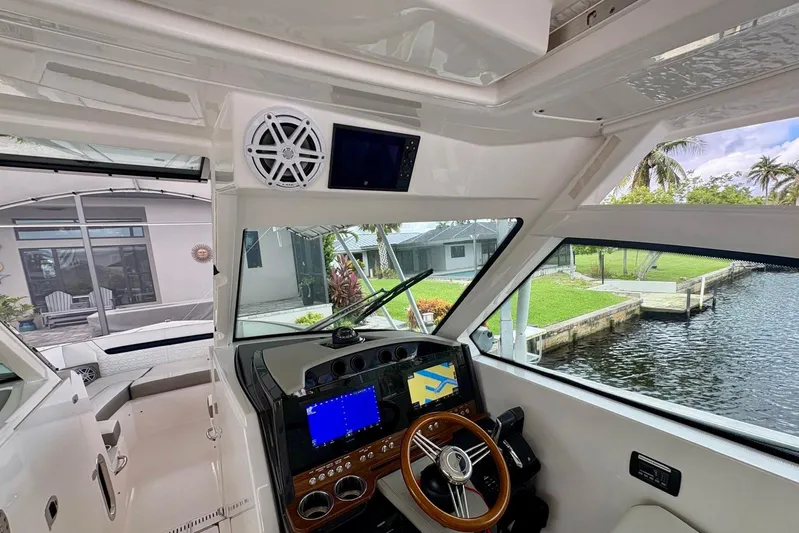 Liquid Asset Yacht Photos Pics 2024 Tiara Yachts 34 LX helm with navigation screens and waterfront view.