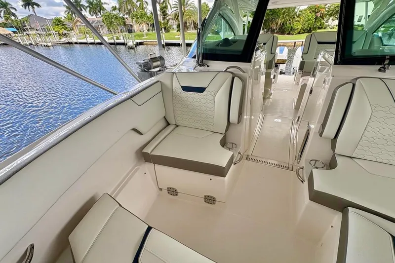 Liquid Asset Yacht Photos Pics 2024 Tiara Yachts 34 LX interior with luxurious seating and waterfront view.