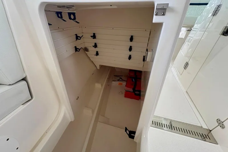 Liquid Asset Yacht Photos Pics 2024 Tiara Yachts 34 LX interior storage compartment with organized shelving.