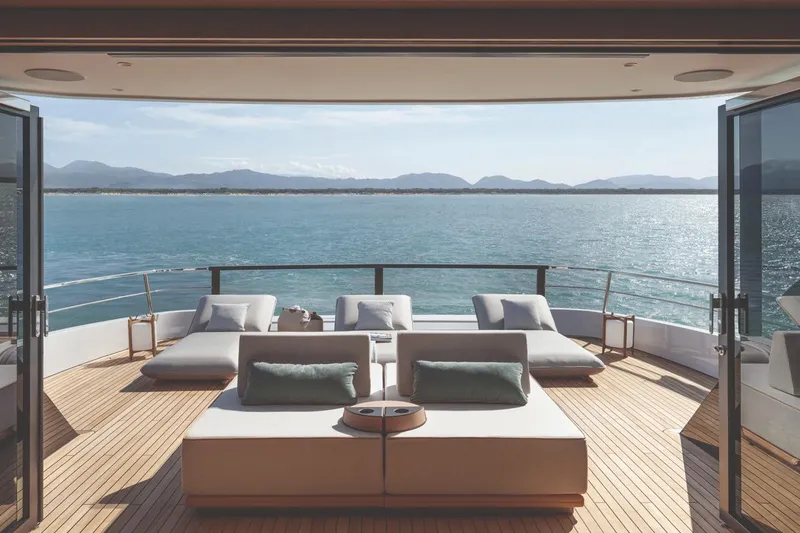  Yacht Photos Pics Luxurious deck view on 2026 Azimut GRANDE 30M yacht, overlooking serene ocean and mountains.
