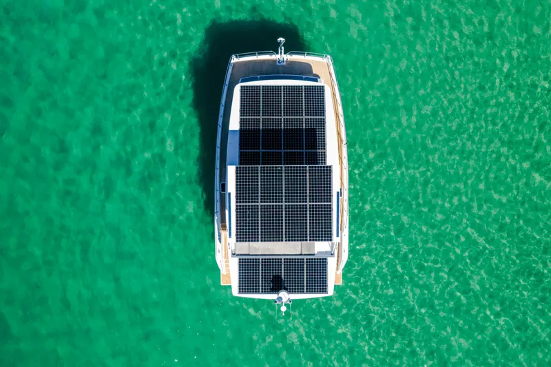  Yacht Photos Pics Top view of 2022 Sunpower 44 VIP yacht with solar panels on turquoise water.