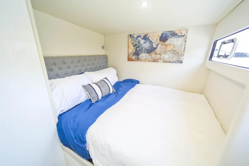  Yacht Photos Pics Luxurious bedroom in 2022 Sunpower 44 VIP yacht with modern decor and cozy bedding.