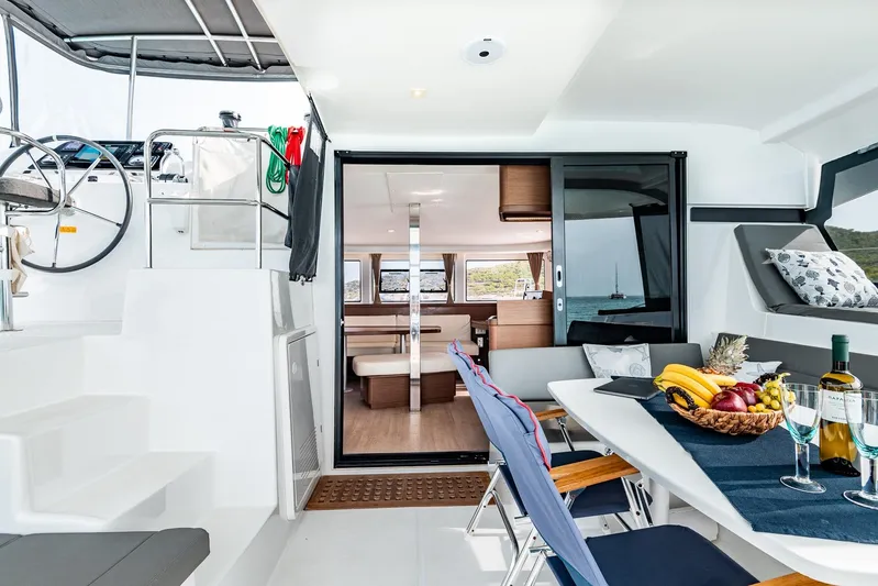  Yacht Photos Pics Luxurious 2018 Lagoon 42 catamaran interior with dining area, fruit basket, and scenic ocean view.