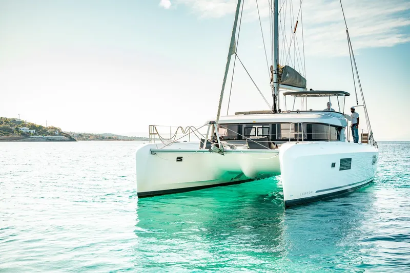 Yacht Photos Pics 2018 Lagoon 42 catamaran sailing on clear turquoise waters.
