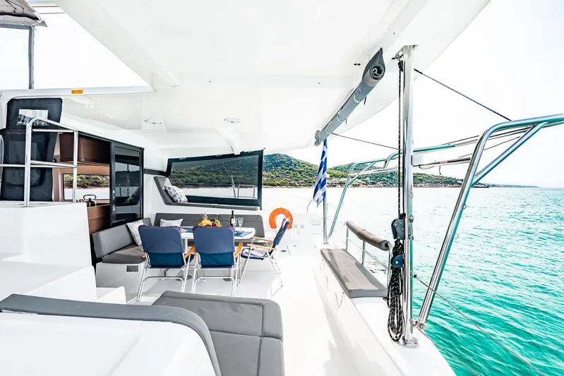  Yacht Photos Pics 2018 Lagoon 42 catamaran with spacious deck, dining area, and scenic ocean view.