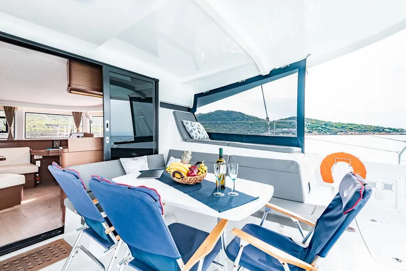  Yacht Photos Pics Luxurious Lagoon 42 catamaran interior, 2018 model, featuring elegant dining setup with ocean view.