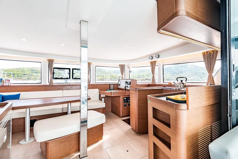  Yacht Photos Pics Interior of 2018 Lagoon 42 catamaran with modern wood finish and spacious seating area.