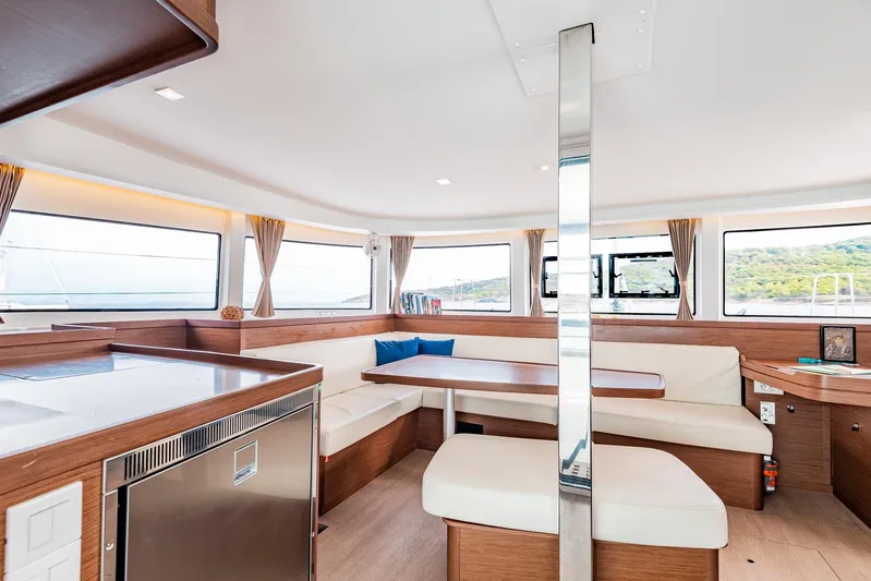  Yacht Photos Pics Spacious interior of 2018 Lagoon 42 catamaran with modern seating and large windows.