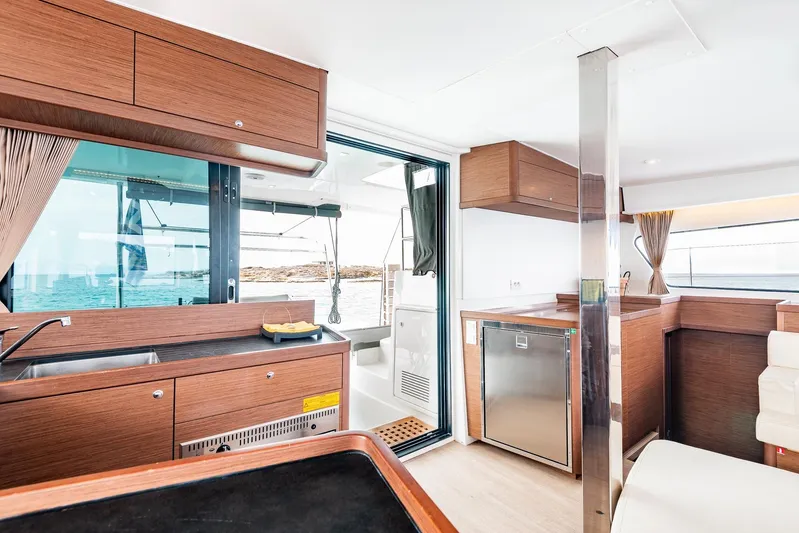 Yacht Photos Pics Interior of 2018 Lagoon 42 catamaran with modern kitchen and ocean view.