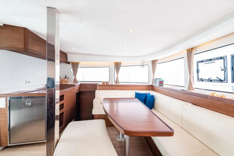  Yacht Photos Pics Interior of 2018 Lagoon 42 yacht with modern dining area and panoramic windows.