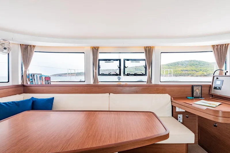  Yacht Photos Pics Interior of 2018 Lagoon 42 catamaran with elegant wood finish and scenic window views.
