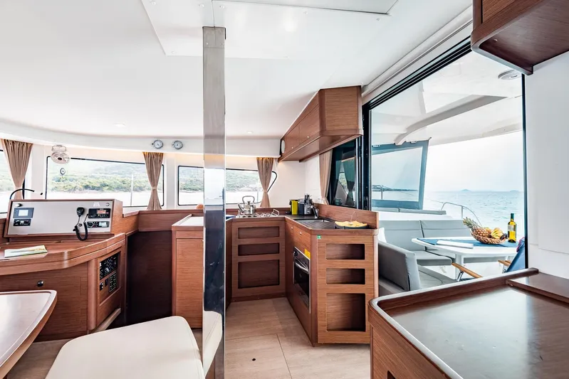  Yacht Photos Pics Interior of 2018 Lagoon 42 catamaran with modern kitchen and ocean view.