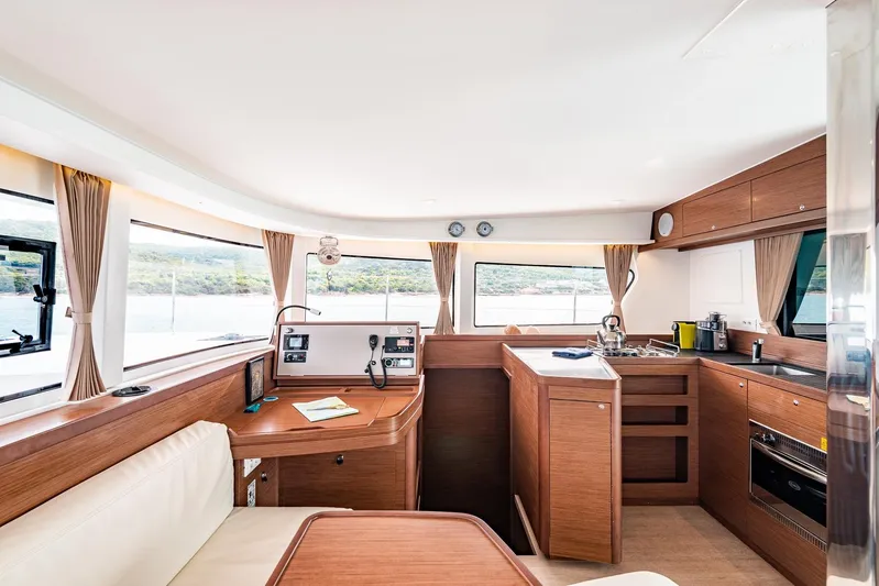  Yacht Photos Pics Interior of 2018 Lagoon 42 yacht, featuring modern kitchen and navigation area with scenic views.
