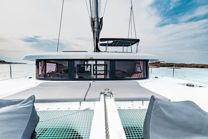  Yacht Photos Pics 2018 Lagoon 42 catamaran on calm waters, featuring spacious deck and modern design.