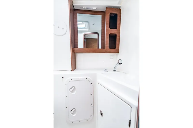  Yacht Photos Pics 2018 Lagoon 42 yacht bathroom with wooden cabinets and modern sink design.