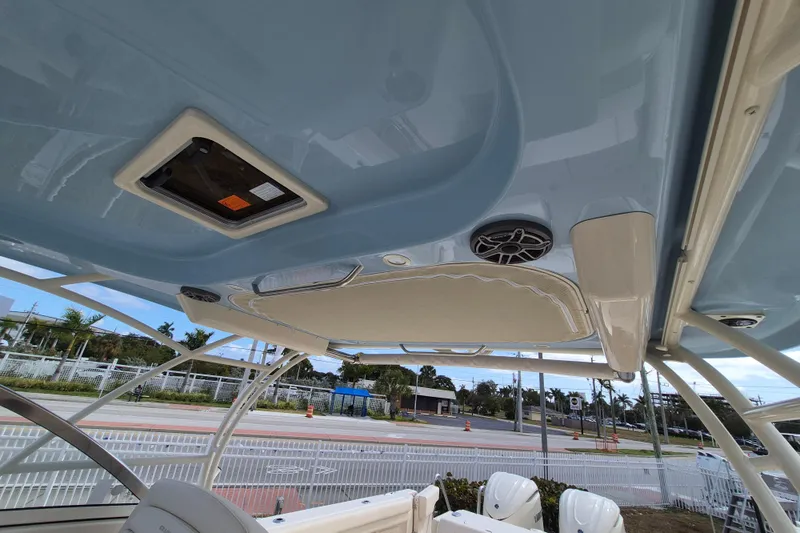 306 - 628 Yacht Photos Pics 2026 Grady-White Freedom 307 boat interior, featuring speakers and hatch, with outdoor view.