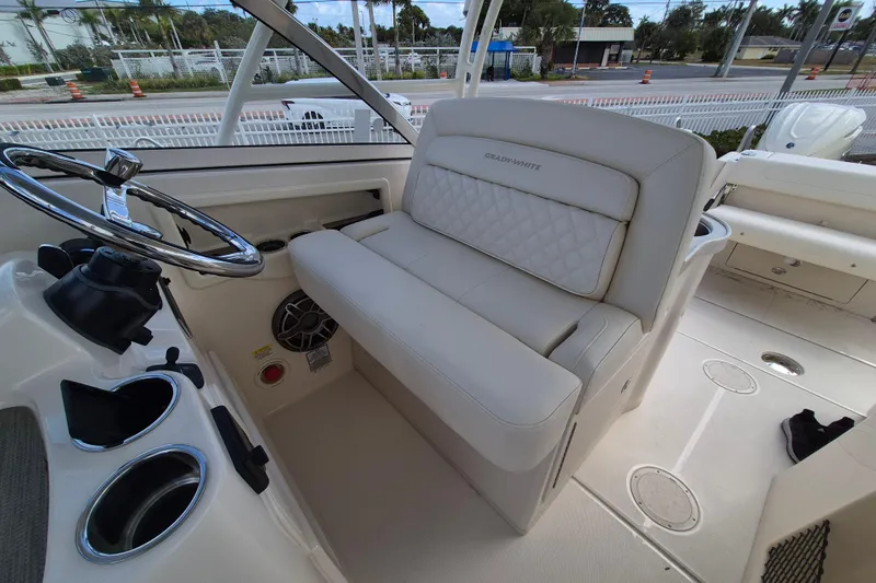 306 - 628 Yacht Photos Pics 2026 Grady-White Freedom 307 boat interior with steering wheel and cushioned seating.