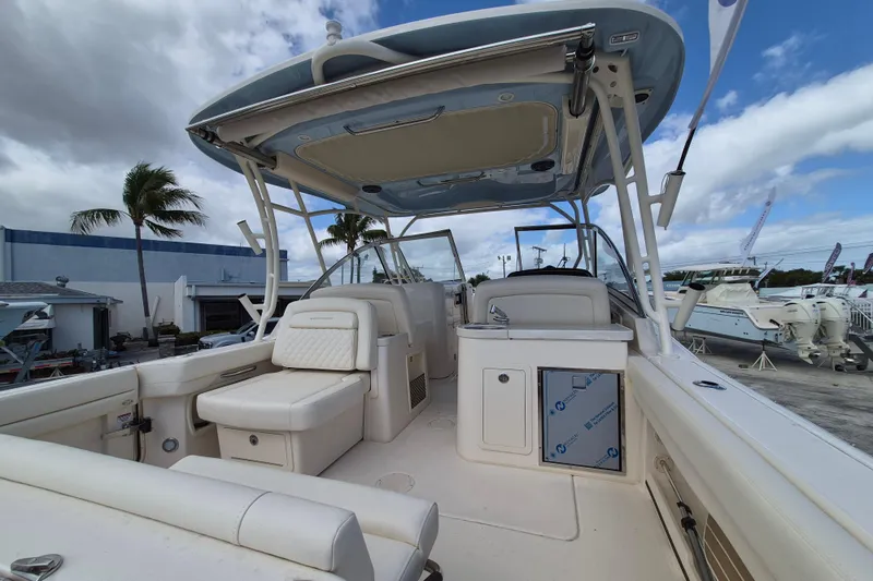 306 - 628 Yacht Photos Pics 2026 Grady-White Freedom 307 boat interior with seating and helm, under a blue sky.