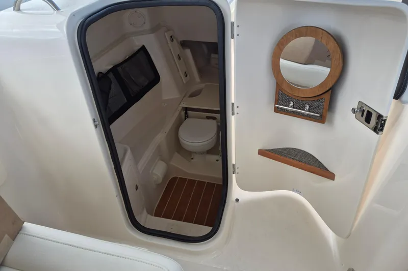 306 - 628 Yacht Photos Pics 2026 Grady-White Freedom 307 boat interior with toilet and mirror.