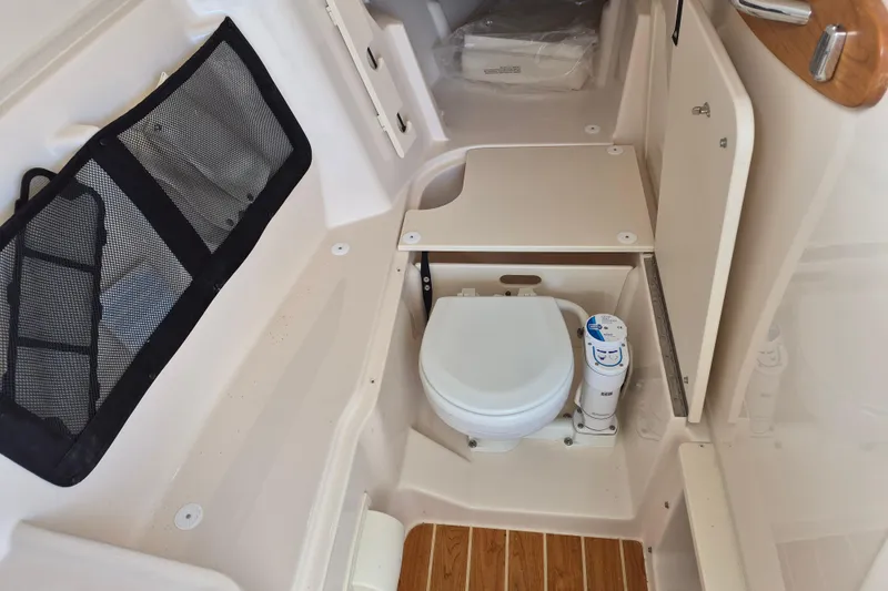 306 - 628 Yacht Photos Pics 2026 Grady-White Freedom 307 boat interior with compact marine toilet and storage.