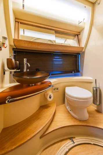 Prime Time Yacht Photos Pics Luxurious bathroom in 2012 Azimut 48 Flybridge yacht with modern fixtures and wooden accents.