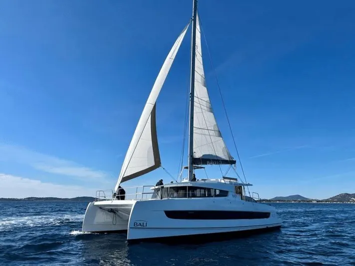 After You Yacht Photos Pics 2023 Bali 4.2 catamaran sailing on open sea under clear blue sky.