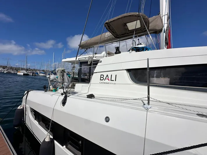 After You Yacht Photos Pics 2023 Bali 4.2 catamaran docked in a marina under a clear blue sky.