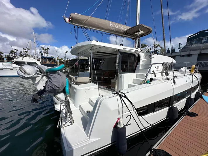 After You Yacht Photos Pics Modern Bali 4.2 catamaran docked at marina, showcasing sleek design and spacious deck.