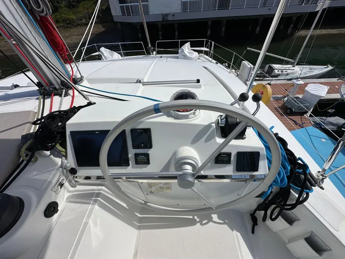 After You Yacht Photos Pics Steering wheel of 2023 Bali 4.2 yacht with navigation controls and dock view.