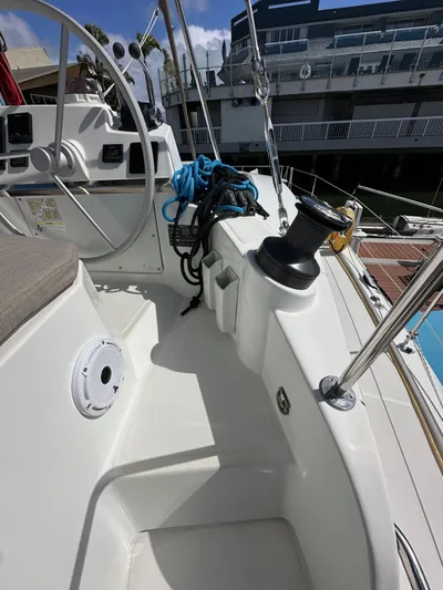 After You Yacht Photos Pics 2023 Bali 4.2 yacht deck with steering wheel and winch, docked at marina.