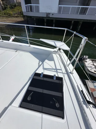 After You Yacht Photos Pics 2023 Bali 4.2 yacht deck with railing and docked boat in background.