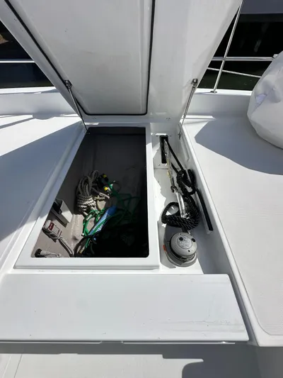 After You Yacht Photos Pics Open storage compartment on 2023 Bali 4.2 yacht deck with ropes and equipment.