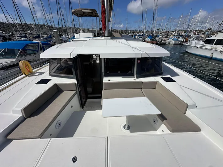 After You Yacht Photos Pics 2023 Bali 4.2 yacht with spacious deck seating and table in marina.