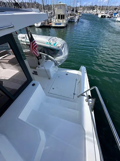 After You Yacht Photos Pics 2023 Bali 4.2 yacht docked in marina, rear view with American flag.