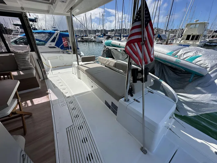 After You Yacht Photos Pics Bali 4.2 yacht interior with American flag, docked at marina, 2023 model.