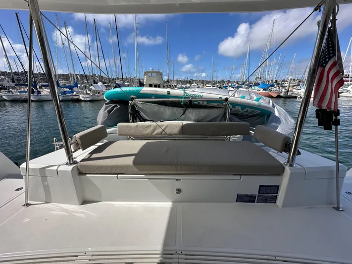 After You Yacht Photos Pics 2023 Bali 4.2 yacht with American flag, docked in marina under blue sky.