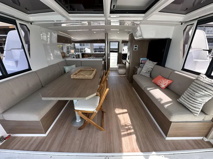 After You Yacht Photos Pics Spacious interior of 2023 Bali 4.2 yacht with modern seating and dining area.