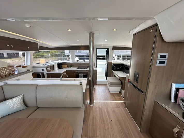 After You Yacht Photos Pics Interior of 2023 Bali 4.2 yacht, featuring modern kitchen and seating area with wood finishes.