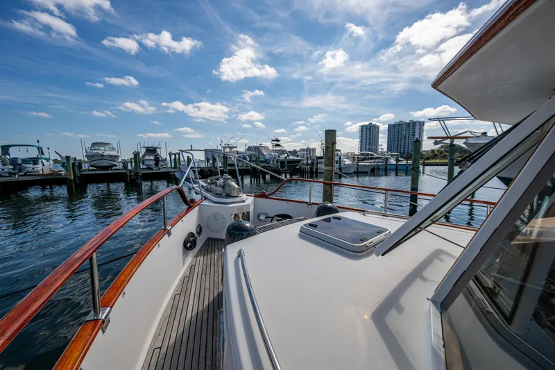  Yacht Photos Pics Grand Banks 42 Classic yacht docked at marina, 2002 model, under a clear blue sky.