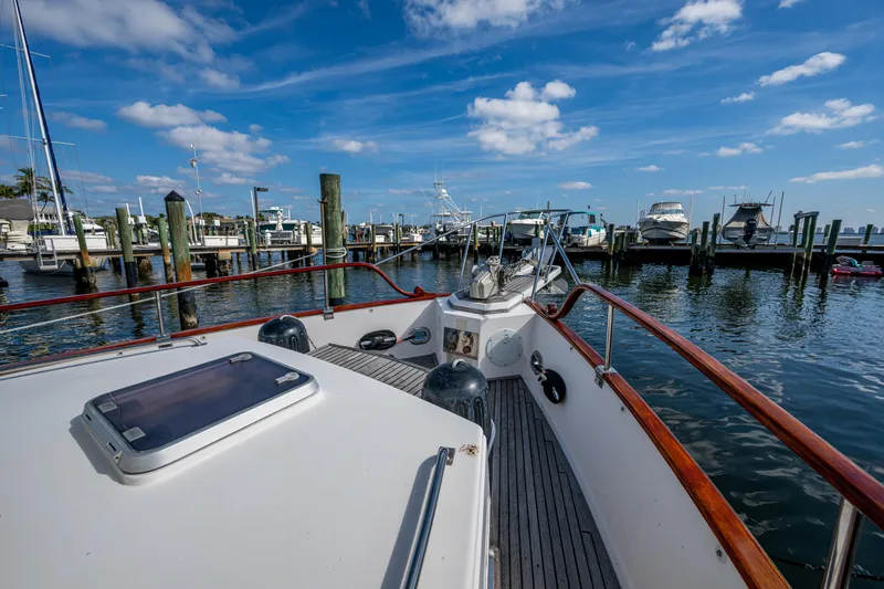  Yacht Photos Pics Grand Banks 42 Classic yacht docked at marina, 2002 model, under a clear blue sky.