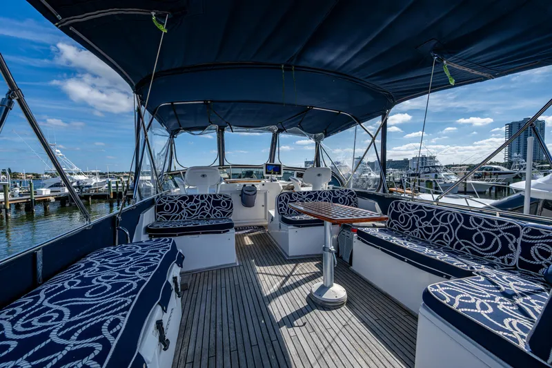  Yacht Photos Pics 2002 Grand Banks 42 Classic yacht interior with blue seating and wooden deck.
